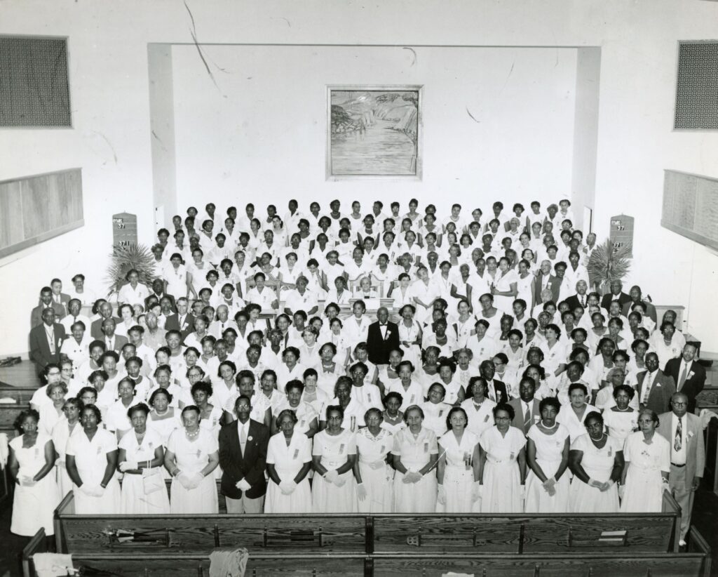 Choir at church with women in dresses and men in suits