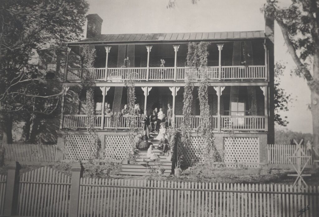 The Magnolia Tavern, with two floors with full width balcony and porch running along the front of the building